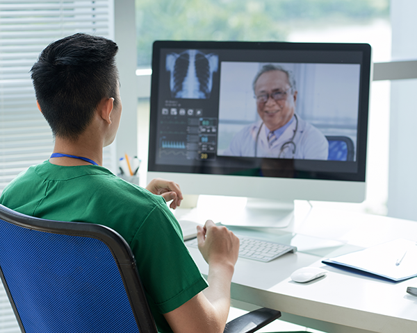 Doctor talks to specialist over video conference